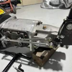 G-Force GF4A Transmission, Buy G-Force GF4A Transmission, GF4A racing gearbox, GF4A four speed, GF4A dog box, GF4A motorsport gearbox, GF4A competition manual, four speed race gearbox, four speed dog transmission, circle track gearbox, road course gearbox, professional racing manual, externally shifted gearbox, external linkage race box, conventional race gearbox, H gate motorsport gearbox, race car H shifter, Long HT4000 shifter, Long four speed shifter, close ratio race shifter, performance H gate shifter, racing linkage assembly, big block Nova gearbox, BBC Nova drivetrain, 1970 Nova race parts, classic Nova transmission, Chevrolet Nova manual swap, big block Chevy gearbox, BBC racing drivetrain, classic Chevrolet race transmission, muscle car dogbox, Pro Street Nova gearbox, Advanced racing clutch, performance clutch assembly, competition clutch package, race clutch system, high load clutch assembly, motorsport clutch setup, clutch pressure tuning, racing clutch inspection, performance clutch servicing, competition clutch hardware, aluminum race flywheel, lightweight performance flywheel, BBC aluminum flywheel, competition flywheel assembly, low inertia flywheel, racing rotating mass, performance flywheel inspection, flywheel friction insert, race engine flywheel setup, manual conversion flywheel, Lakeside bellhousing, Lakeside clutch housing, BBC racing bellhousing, Chevrolet competition housing, performance clutch enclosure, race bellhousing fitment, clutch housing alignment, manual transmission housing, big block bellhousing setup, competition bellhousing package, dual bearing gearbox, center support transmission, integrated midplate gearbox, race shaft support, countershaft support plate, mainshaft bearing support, reinforced racing gearbox, rigid competition transmission, shaft separation control, motorsport midplate design, magnesium race transmission, magnesium gearbox housing, lightweight gearbox case, magnesium tailhousing, reinforced transmission case, coated gearbox housing, race transmission case inspection, magnesium case repair, lightweight four speed, competition gearbox construction, 32 tooth output shaft, hardened slip yoke, competition driveshaft yoke, race gearbox output, high load output spline, performance driveshaft connection, motorsport driveline yoke, race prop shaft setup, competition driveline alignment, custom driveshaft fitment, interchangeable race gears, changeable gearbox ratios, custom race gearset, competition ratio selection, close ratio gearset, race gear ratio tuning, track gearing configuration, final drive matching, motorsport ratio calculator, race gear spacing, internal gearbox oil pump, gear driven transmission pump, race gearbox cooler system, competition transmission lubrication, motorsport oil circulation, gearbox cooler plumbing, racing gearbox oil system, transmission pump inspection, track gearbox cooling, performance transmission lubrication, used four speed transmission, low use racing gearbox, lightly used race transmission, used motorsport manual, second hand racing gearbox, used dogbox package, competition gearbox condition, racing transmission inspection, preowned performance gearbox, used track transmission, circle racing drivetrain, road racing drivetrain, track car manual gearbox, endurance racing transmission, touring car gearbox, stock car race gearbox, circuit competition transmission, hill climb manual gearbox, time attack four speed, race prepared transmission, high power manual gearbox, extreme duty transmission, professional motorsport driveline, competition powertrain package, racing gearbox upgrade, performance drivetrain conversion, stick shift race car, manual race vehicle, high output driveline, race gearbox service, competition transmission rebuild, gearbox bearing inspection, dog engagement inspection, shift linkage servicing, motorsport transmission refresh, gearbox seal inspection, transmission case evaluation, racing gear inspection, professional gearbox maintenance, GF4A replacement parts, GF4A rebuild components, GF4A gearbox service, GF4A shifter parts, GF4A gearset parts, motorsport gearbox supplier, used racing transmission dealer, competition gearbox retailer, race drivetrain marketplace, specialist transmission seller, four speed gearbox package, racing transmission package, performance manual purchase, used dogbox for sale, track gearbox purchase, race transmission freight, gearbox pallet delivery, motorsport drivetrain shipping, competition transmission transport, international gearbox freight, TorqueLine racing gearboxes, TorqueLine competition transmissions, TorqueLine used drivetrains, TorqueLine performance manuals, TorqueLine motorsport parts