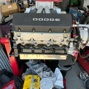 R5P7 NASCAR Engine, Buy R5P7 NASCAR Engine, Dodge 358 race motor for sale, 358 cubic inch race V8, Dodge stock car motor, ex NASCAR Dodge motor, professional stock car powerplant, Dodge Cup Series motor, former racing V8, used stock car powerplant, competition Dodge small block, high revving Mopar V8, Mopar stock car powerplant, purpose built Dodge V8, naturally aspirated Dodge racer, 12 to 1 compression engine, JE piston race motor, JE competition pistons, Bryant racing crankshaft, Bryant eight bolt crank, 3.253 stroke crankshaft, short stroke race motor, eight bolt Mopar crank, racing rotating assembly, competition crankshaft package, Jesel timing belt drive, Jesel cam drive, carbon fiber timing cover, racing timing belt system, keyed roller lifters, bushed roller lifters, roller valvetrain Dodge, competition roller cam, racing camshaft Mopar, high RPM valvetrain, P7 racing heads, Mopar racing cylinder heads, competition cylinder head engine, stock car valvetrain, stainless fabricated oil pan, fabricated racing sump, external lubrication motor, racing dry sump package, competition oil pump, BMRS racing hoses, BMRS oil fittings, braided race oil lines, external oil plumbing, racing oil system hardware, CV Products fuel pump, billet mechanical fuel pump, racing fuel delivery pump, competition fuel system, ATI racing damper, ATI harmonic balancer, performance crank damper, race ignition distributor, competition spark plug wires, racing ignition hardware, race power steering pump, engine mounted steering pump, motorsport steering pump, Mopar competition intake, racing intake manifold Dodge, high flow Mopar intake, NASCAR induction system, carbureted racing V8, racing carburetor motor, race engine documentation, documented racing motor, engine specification sheet, NASCAR engine build records, race engine history records, used race motor records, borescope inspected engine, cylinder wall borescope, used engine internal inspection, racing cylinder condition, low run time race engine, recently serviced race motor, freshened competition motor, used race engine health check, valve spring pressure test, racing valve lash inspection, race bearing inspection, dry sump pump inspection, motorsport engine evaluation, professional race engine inspection, stock car motor inspection, competition engine pre purchase check, used performance motor checklist, racing engine service history, motorsport engine maintenance, high RPM engine service, race motor preparation, engine dyno preparation, racing V8 dyno test, competition motor calibration, naturally aspirated dyno tuning, high compression race tuning, race fuel requirement guide, competition ignition timing, racing engine RPM limits, race motor cooling requirements, stock car cooling system, motorsport radiator setup, racing exhaust fabrication, competition headers Dodge, custom race exhaust, racing engine mounting, custom Mopar motor mounts, race transmission adaptation, stock car transmission adapter, racing bellhousing conversion, competition clutch setup, race flywheel compatibility, eight bolt flywheel, racing driveshaft setup, motorsport drivetrain conversion, drag car Dodge motor, drag and drive Mopar motor, burnout car Dodge engine, race boat Mopar motor, circuit racing Dodge V8, track car Mopar motor, custom Dodge race project, classic Mopar race conversion, specialist motorsport build, custom race chassis engine, tube chassis Dodge motor, race car fabrication engine, performance engine online sale, specialist race motor dealer, competition powerplant retailer, used racing engine supplier, Dodge motorsport engine shop, Mopar racing motor retailer, stock car engine marketplace, professional race motor sales, high performance V8 dealer, rare Dodge racing motor, motorsport powertrain supplier, competition engine catalogue, racing engine freight shipping, stock car motor transport, palletized race engine shipping, motorsport engine freight quote, international engine transportation, racing V8 delivery service, competition motor logistics, engine crate freight, race motor collection, performance engine shipping, TorqueLine Dodge racing, TorqueLine motorsport V8, TorqueLine race powerplants, TorqueLine used racing motors, TorqueLine performance engines, TorqueLine Mopar components, TorqueLine engine sales, TorqueLine fitment support, TorqueLine race parts store, TorqueLine motorsport catalogue, Dodge race engine purchase, used NASCAR motor purchase, professional racing V8 enquiry, specialist Dodge powertrain, competition Mopar engine supplier, high RPM V8 purchase, stock car engine buying guide, Dodge racing engine buying guide, used motorsport motor guide, NASCAR powerplant specifications