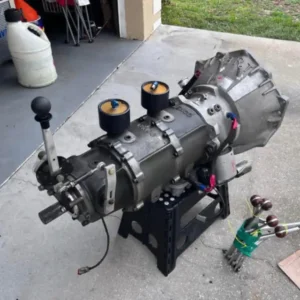 Bruno Lenco Transmission, Buy Bruno Lenco Transmission, BRT converter drive gearbox, BRT Chevy racing gearbox, CS2 planetary gearbox, 1.41 ratio race gearbox, two speed drag gearbox, pneumatic shift race gearbox, converter driven drag gearbox, Chevy race gearbox package, modular drag racing gearbox, professional race drivetrain, CS2 air pod setup, pneumatic Lenco controls, air shifted planetary gearbox, drag gearbox air system, race transmission solenoid setup, ACD transmission controller, ACD pneumatic shifter, electronic race shift control, drag car shift controller, racing shift solenoids, Lightning Rod shift system, Lightning Rod race shifter, drag racing shift hardware, race cockpit shifter setup, competition gear selector, Simpson gearbox blanket, race drivetrain containment blanket, drag transmission safety cover, gearbox containment equipment, competition drivetrain safety, Chevy bellhousing race setup, BRT Chevrolet bellhousing, Chevrolet converter drive setup, Chevy drag drivetrain, big block Chevy race gearbox, small block Chevy race gearbox, LS race transmission adapter, Chevy race bellhousing fitment, drag car bellhousing setup, competition Chevy drivetrain, planetary transmission reverser, drag gearbox reverse unit, CS2 reverse assembly, racing transmission reverse gear, modular gearbox reverser, 1.41 first gear drag setup, 1.41 planetary ratio, drag racing first gear selection, race transmission ratio selection, converter car gearing, rear gear calculator drag car, tire diameter gearing race car, launch ratio drag racing, final drive drag setup, direct drive racing gearbox, 1 to 1 race transmission, converter stall race setup, torque converter race drivetrain, high stall converter gearbox, drag converter tuning, converter pressure adjustment, racing converter calibration, transbrake converter drivetrain, air transbrake race setup, drag car launch system, high horsepower converter setup, race converter matching, planetary clutch pack service, race gearbox bearing inspection, transmission seal replacement racing, drag gearbox maintenance, CS2 service procedure, planetary gear inspection, race transmission fluid service, converter drive fluid change, gearbox lubrication race car, racing transmission precheck, used race gearbox inspection, drag transmission rebuild service, race gearbox condition check, competition transmission maintenance, pneumatic shifter plumbing, race car air bottle setup, CO2 gearbox shifting, air regulator race transmission, pneumatic solenoid wiring, race shift pressure setup, drag car air line routing, transmission controller wiring, automated race shifting, RPM activated gear change, drag shift timing setup, two speed race car setup, two ratio drag transmission, simplified drag drivetrain, lightweight racing gearbox setup, compact race transmission, space saving drag gearbox, Pro Mod drivetrain components, Top Dragster gearbox parts, supercharged drag car transmission, nitrous drag drivetrain, boosted race gearbox, high output racing drivetrain, dragster transmission package, door car racing gearbox, tube chassis drivetrain, competition transmission assembly, race car driveline package, custom drag drivetrain, drag transmission installation, race gearbox mounting, transmission crossmember racing, driveshaft setup drag car, race transmission alignment, bellhousing alignment race car, driveline angle drag racing, transmission tunnel clearance, race car converter installation, race flexplate compatibility, race input shaft fitment, transmission spline identification, torque converter spline matching, racing crank adapter setup, starter clearance bellhousing, Chevy flexplate race setup, drag racing transmission supplier, used planetary gearbox dealer, competition gearbox marketplace, race transmission parts store, high performance gearbox seller, drag drivetrain retailer, racing transmission specialist, used drag gearbox supplier, motorsport drivetrain dealer, race gearbox package sale, professional drag parts supplier, complete race transmission package, air shifted gearbox for sale, two speed race transmission sale, converter drive transmission sale, Chevrolet race gearbox sale, planetary race transmission package, used racing driveline parts, race transmission freight, gearbox pallet shipping, drag transmission delivery, competition drivetrain transport, heavy gearbox freight service, nationwide race parts shipping, international transmission freight, motorsport gearbox logistics, race drivetrain crate shipping, performance parts transportation, TorqueLine drag transmissions, TorqueLine race gearboxes, TorqueLine Chevy drivetrains, TorqueLine planetary transmissions, TorqueLine competition gearboxes, TorqueLine drag racing parts, TorqueLine used transmissions, TorqueLine drivetrain components, TorqueLine transmission freight, TorqueLine performance drivetrains